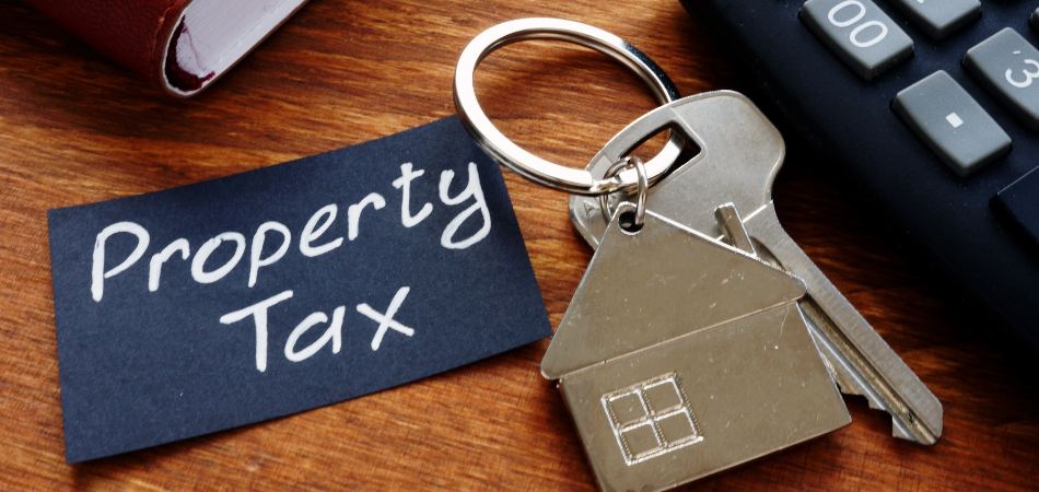  A house key with a paper that says Property Tax
