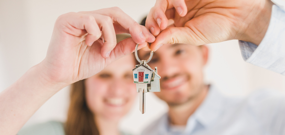 A couple holding a house key